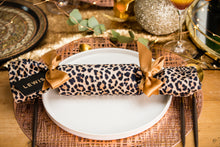 Load image into Gallery viewer, Personalised Christmas crackers at table with gold accessories
