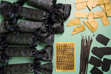 Load image into Gallery viewer, Inside a box of Kaneo Christmas crackers